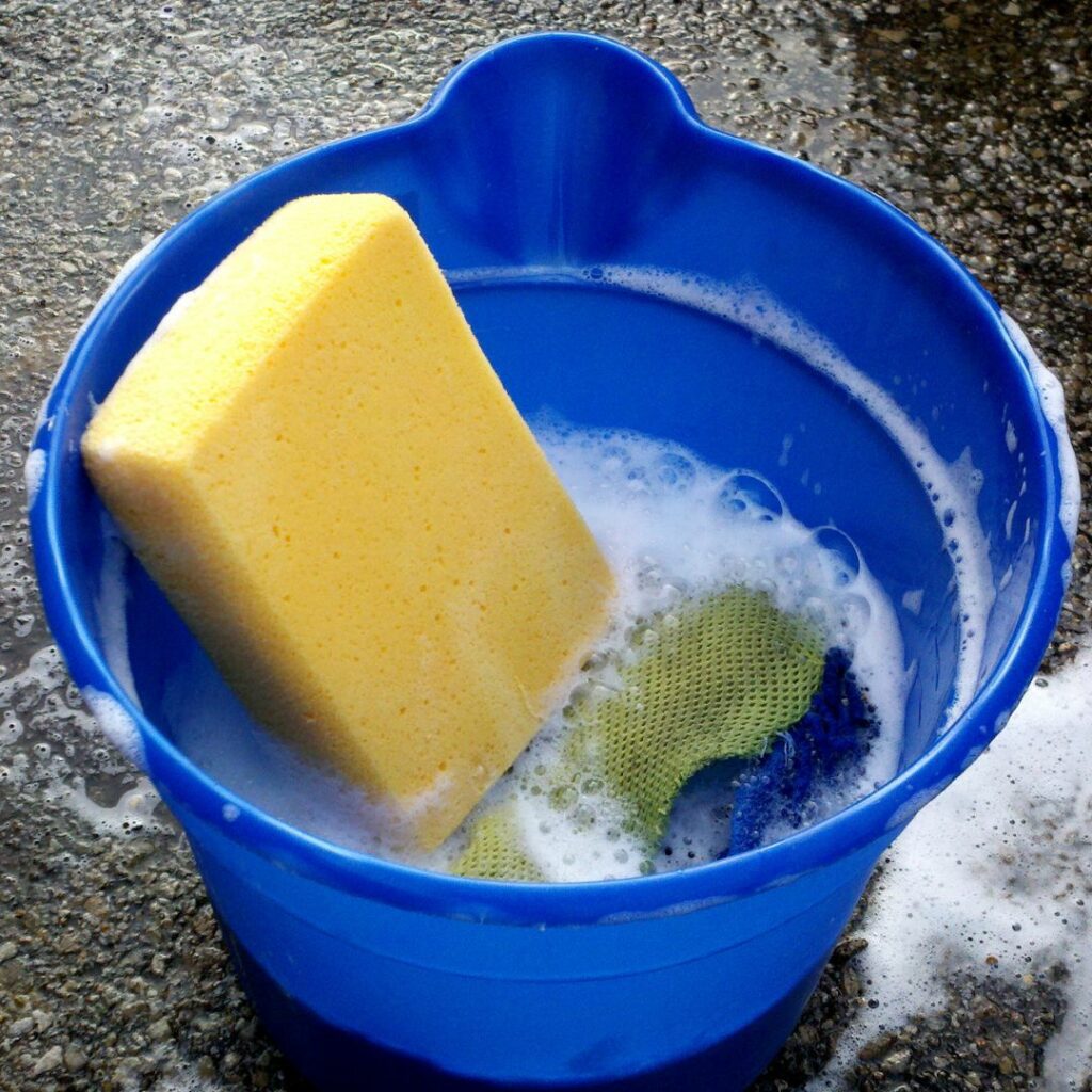 a yellow sponge in a blue bucket