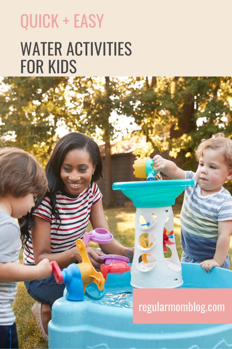 a mother and two kids are outside and playing in a water table
