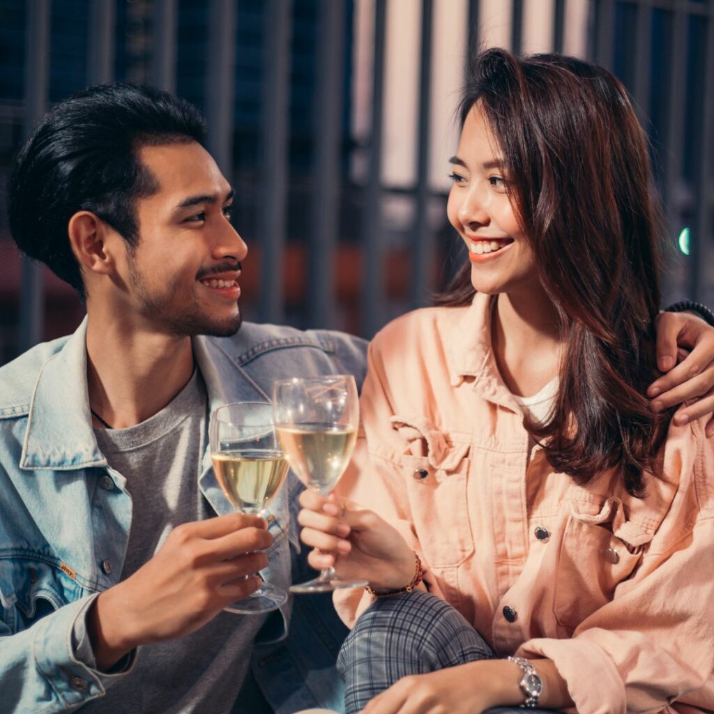 Happy Asian Couple Toasing Drink on at home Date Night for parents