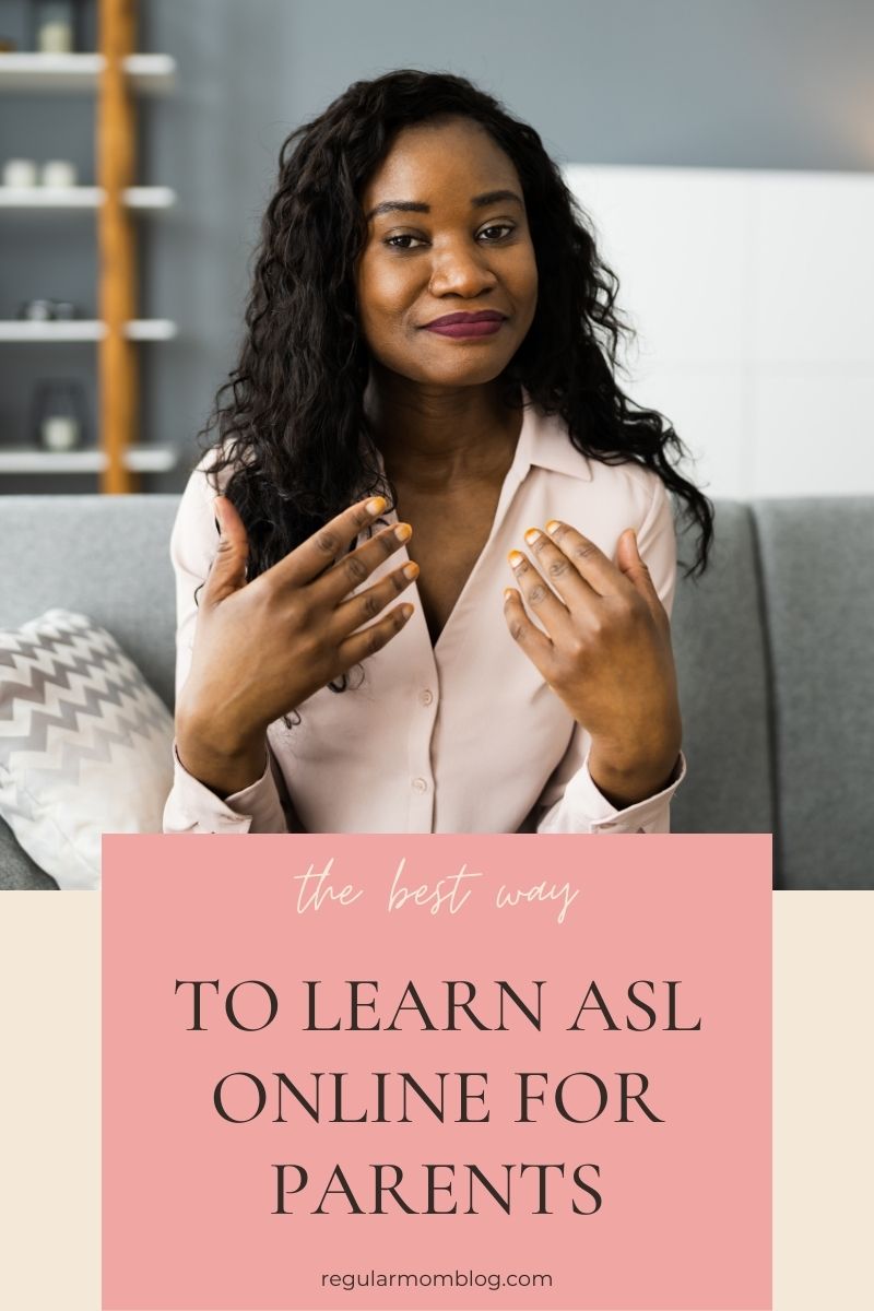 a black woman sits in her living room and learns ASL online