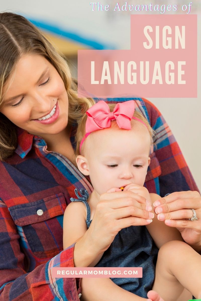 a baby girl and mother sit on the floor and learn to sign the word for more in ASL