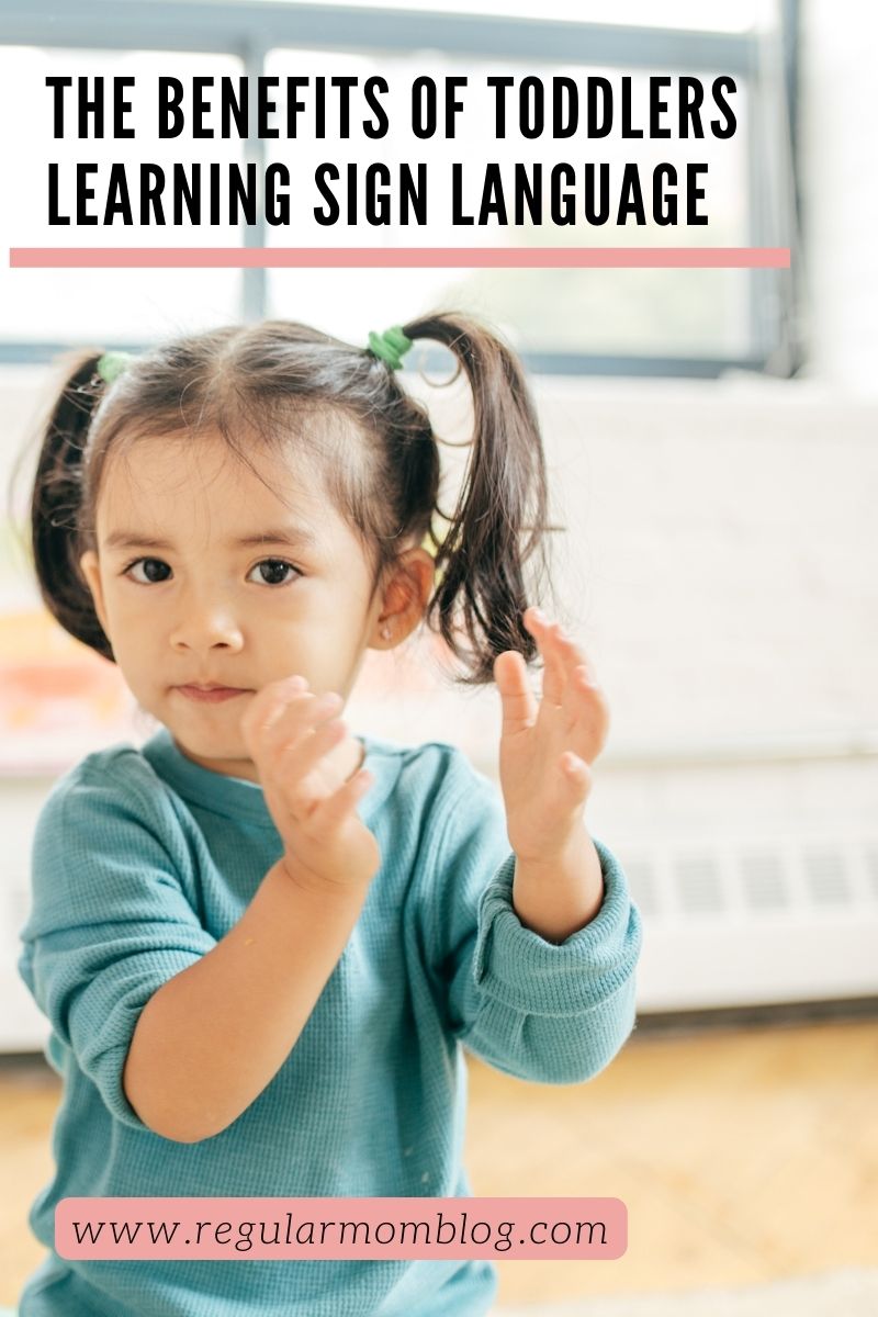 a blog graphic featuring a toddler girl clapping her hands and attempting to use sign language